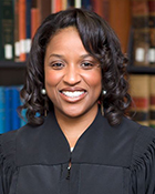 A headshot photo of a woman in a judge's robe