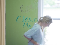 A female student cleans a green room