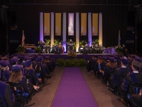 A stage with purple and gold banners