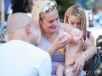 A woman feeds a baby a bottle