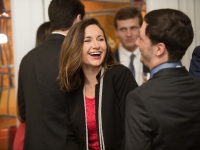 A female students smiles as she talks to a male student