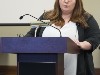 A female student speaks at a podium