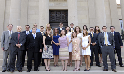 18 students and 3 professors stand on the front steps of the LSU Law Center