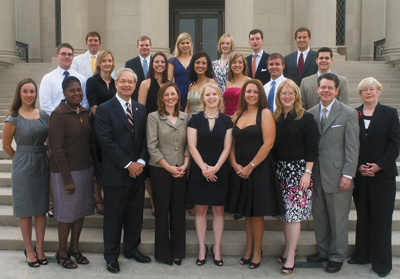 17 students and 5 faculty members pose on the front steps of the LSU Law Center