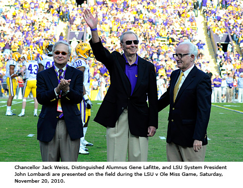 A man waves to the crowd at a football game