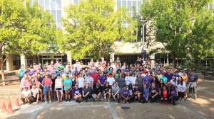 A group of people pose for a photo outside the LSU Law Center