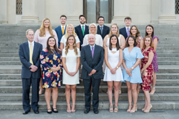 students and faculty stand on the front steps of the LSU Law Center