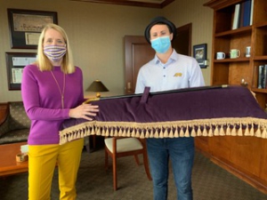 LSU Law Interim Dean Lee Ann Lockridge and 3L Class President Keifer Ackley present the cane that the very first class of graduating LSU Law students presented to Dean Joseph I. Kelly in 1908 during the virtual 2020 Hats 'n Canes Toast.