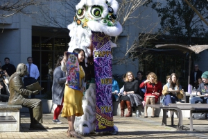 Society for Asian Lawyers President Phiyen Phan poses with a member of the Southern Lotus Lion Dance Association at the close of this year's Lunar New Year celebration at the Paul M. Hebert Law Center.