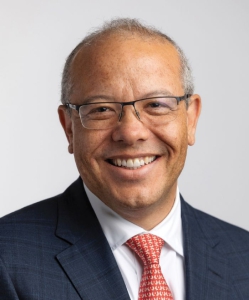 Judge Darrel Papillion smiling in front of a blank background.