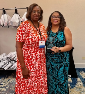 Piper Griffin and Yvette Alexander smiling at the conference.