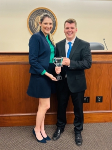 LSU Law 2L Patrick Riley poses with the 2024 Dean’s Cup trophy and 3L Madeline McKenzie Connelly, who won last year’s Dean’s Cup and helped organize this year’s tournament as Director of Internal Appellate Competitions for the Board of Advocates.