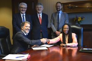 Professor Mustapha Mekki and LSU Law Dean Alena Allen shake hands after signing the MOU between the INFN and LSU Paul M. Hebert Law Center on Tuesday, April 23. Standing behind the two are Professor Philippe Pierre, Professor Olivier Moréteau, and Cultural Attaché Jacques Baran of the Consulate General of France in Louisiana. 