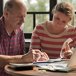 Image of individuals working on tax documents