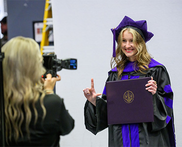Students taking photos at the Grad Fair